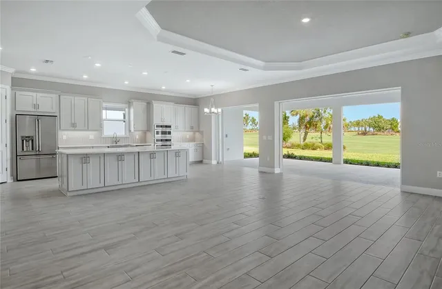 a kitchen with stainless steel appliances white cabinets and a refrigerator