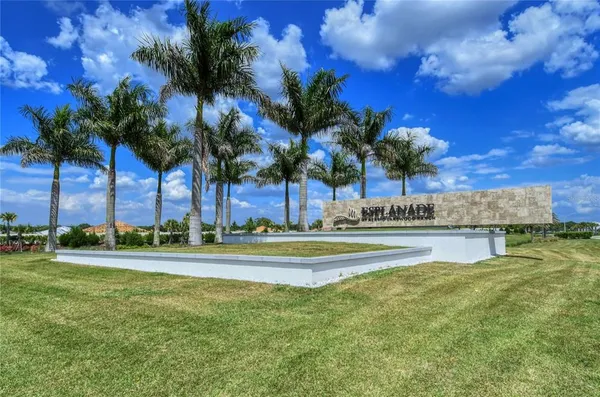 a kitchen with a table chairs refrigerator and cabinets