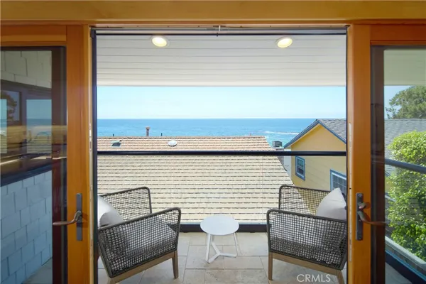 a view of a chair and tables in the balcony