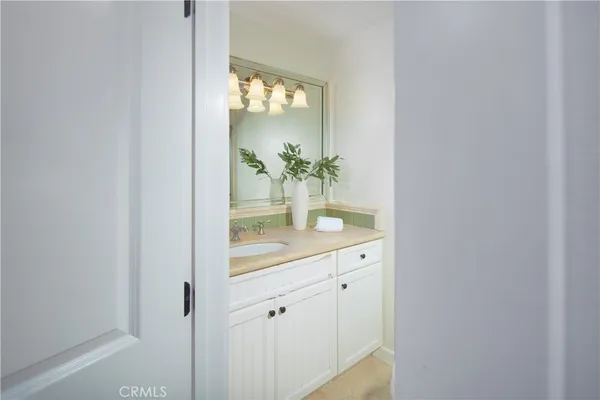 a bathroom with a glass door shower and a sink
