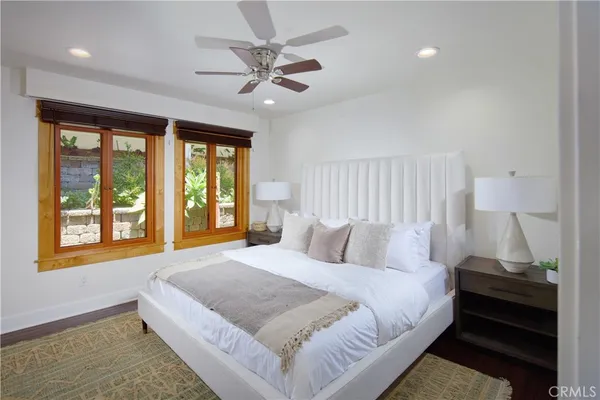 a bedroom with a large bed and a window