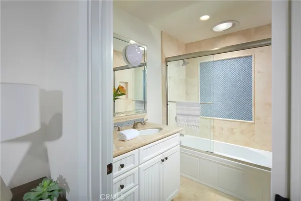 a bathroom with a granite countertop sink mirror and a