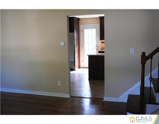 19 Highfield Road Colonia, NJ 07067 - Photo 3 of 17 a view of a hallway with wooden floor and stairs