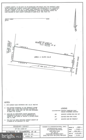 a view of a forest with trees in the background