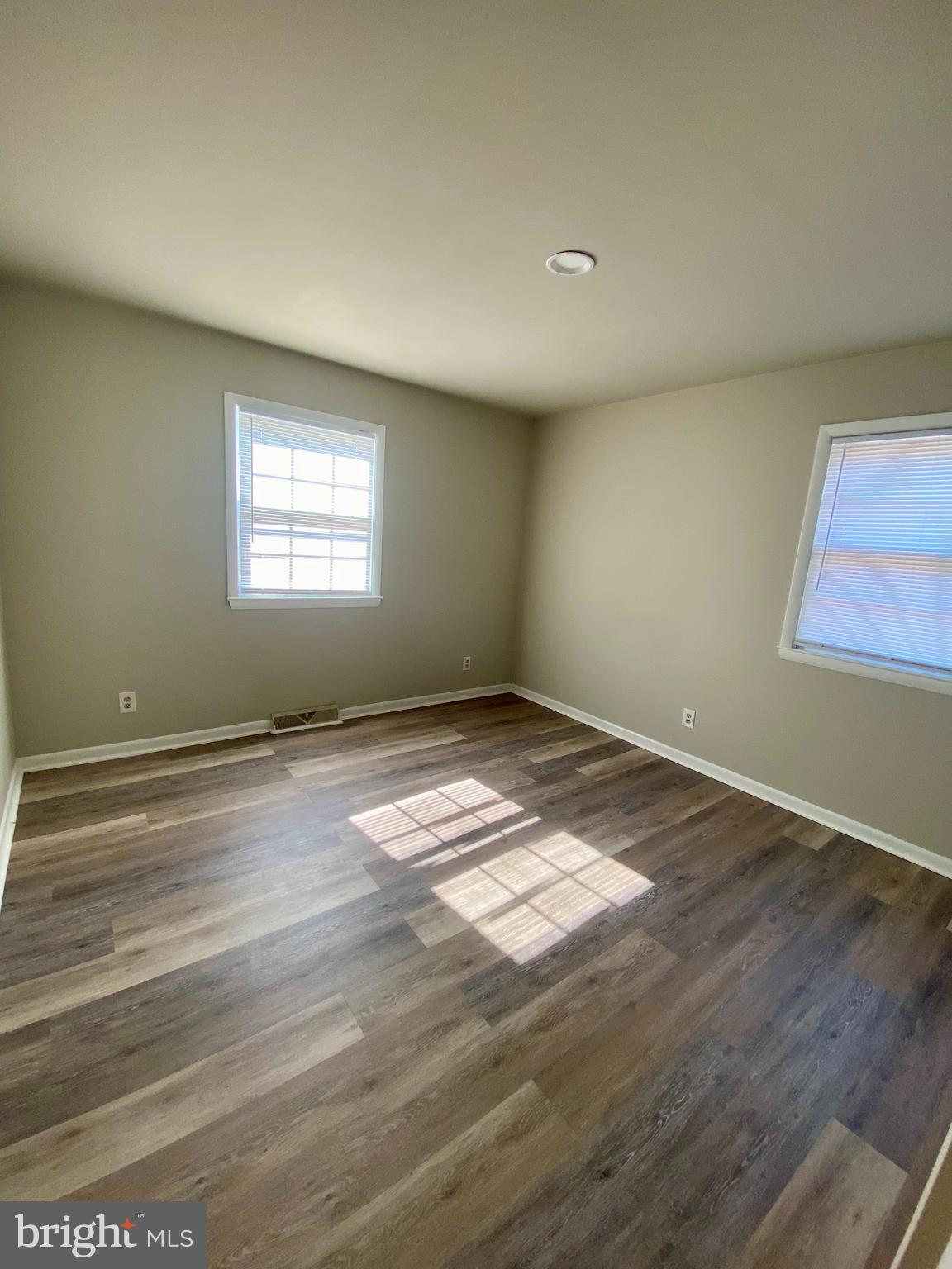 1419 Dandridge Street, Unit A Fredericksburg, VA 22401 - Photo 3 of 8 an empty room with wooden floor and windows