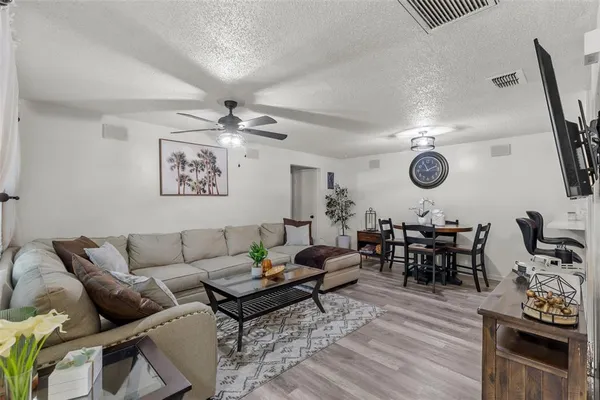 a living room with furniture and wooden floor