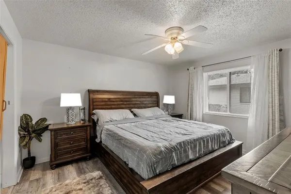 a bedroom with a bed and a chandelier