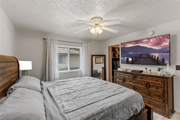 a bedroom with a bed and dresser with mirror