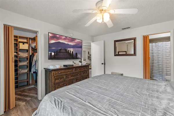 a bedroom with a bed and a flat screen tv