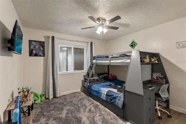 a view of a workspace with furniture and flat screen tv