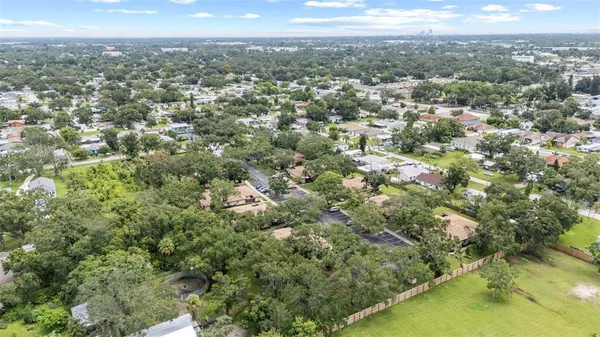 a view of a city with lush green forest
