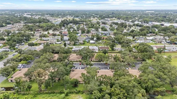 an aerial view of residential house with outdoor space and trees
