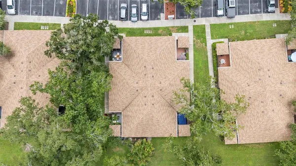 an aerial view of a house with a yard