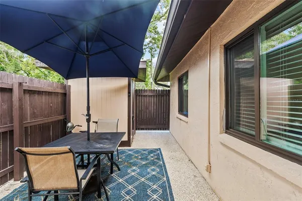 a view of balcony with furniture and umbrella