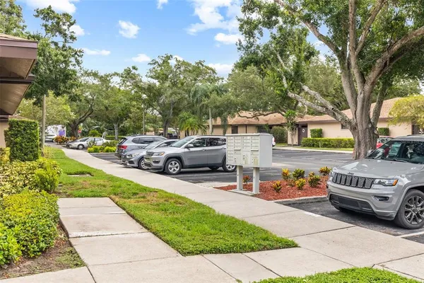 a view of a patio with a table and chairs under an umbrella