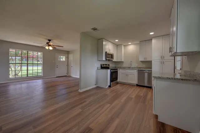 a view of kitchen with sink microwave and stove