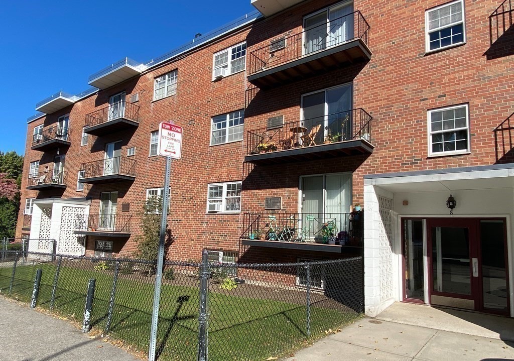 8 Robinwood Avenue, Unit 6 Boston, MA 02130 - Photo 1 of 5 a front view of a house with a backyard