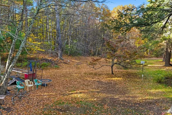 a backyard of a house with table and chairs