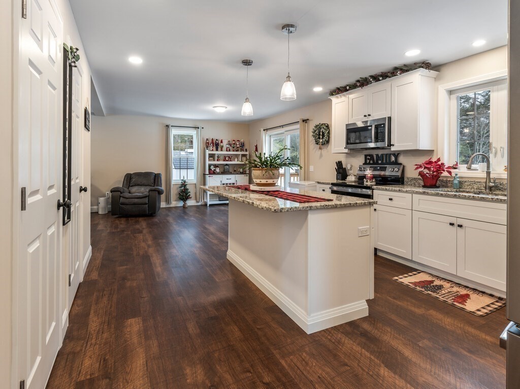 46 Baldwinville State Road Winchendon, MA 01475 - Photo 4 of 37 a kitchen with kitchen island granite countertop a sink cabinets and wooden floor