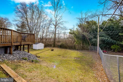 a view of a backyard with wooden fence