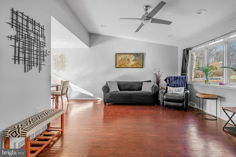 a living room with furniture and a wooden floor