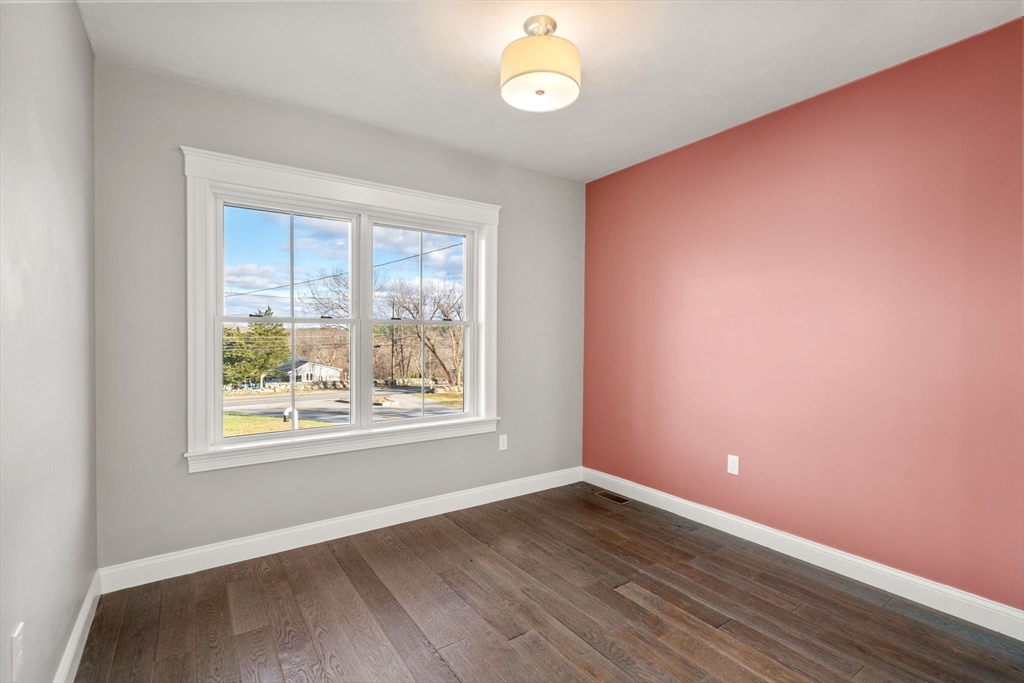 93 Providence Street, Unit B Mendon, MA 01756 - Photo 17 of 37 an empty room with wooden floor and windows