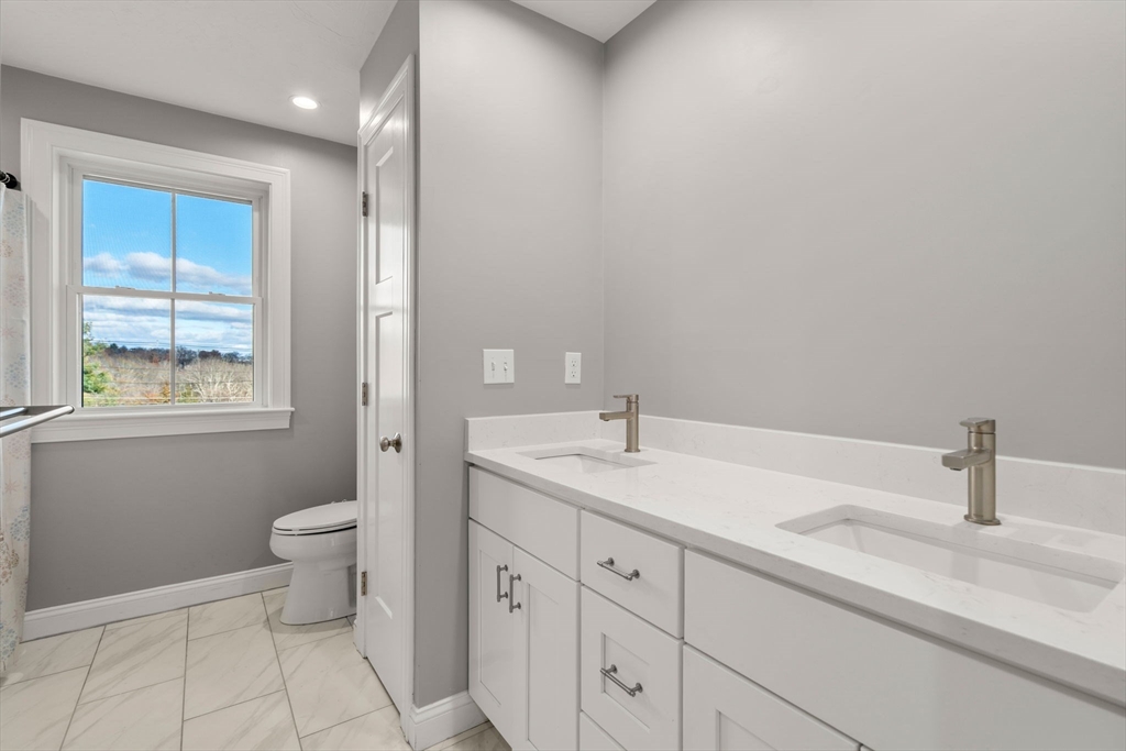 93 Providence Street, Unit B Mendon, MA 01756 - Photo 22 of 37 a bathroom with a sink a toilet and a mirror