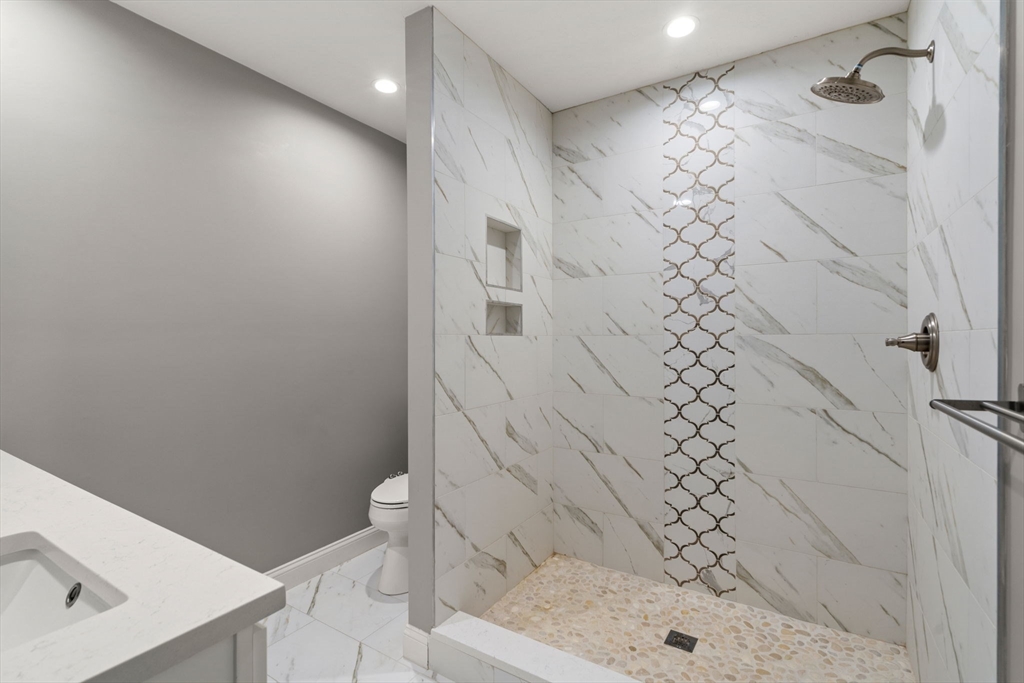 93 Providence Street, Unit B Mendon, MA 01756 - Photo 4 of 37 a bathroom with a shower toilet and sink