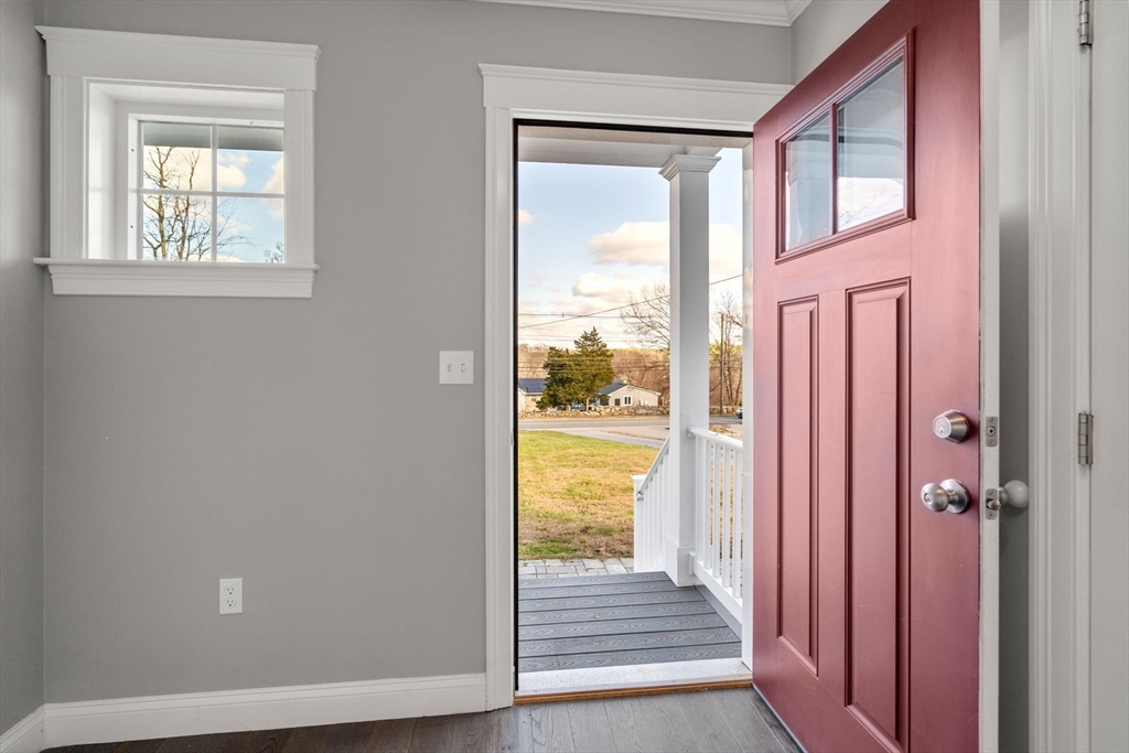 93 Providence Street, Unit B Mendon, MA 01756 - Photo 6 of 37 a view of a hallway with wooden floor and windows