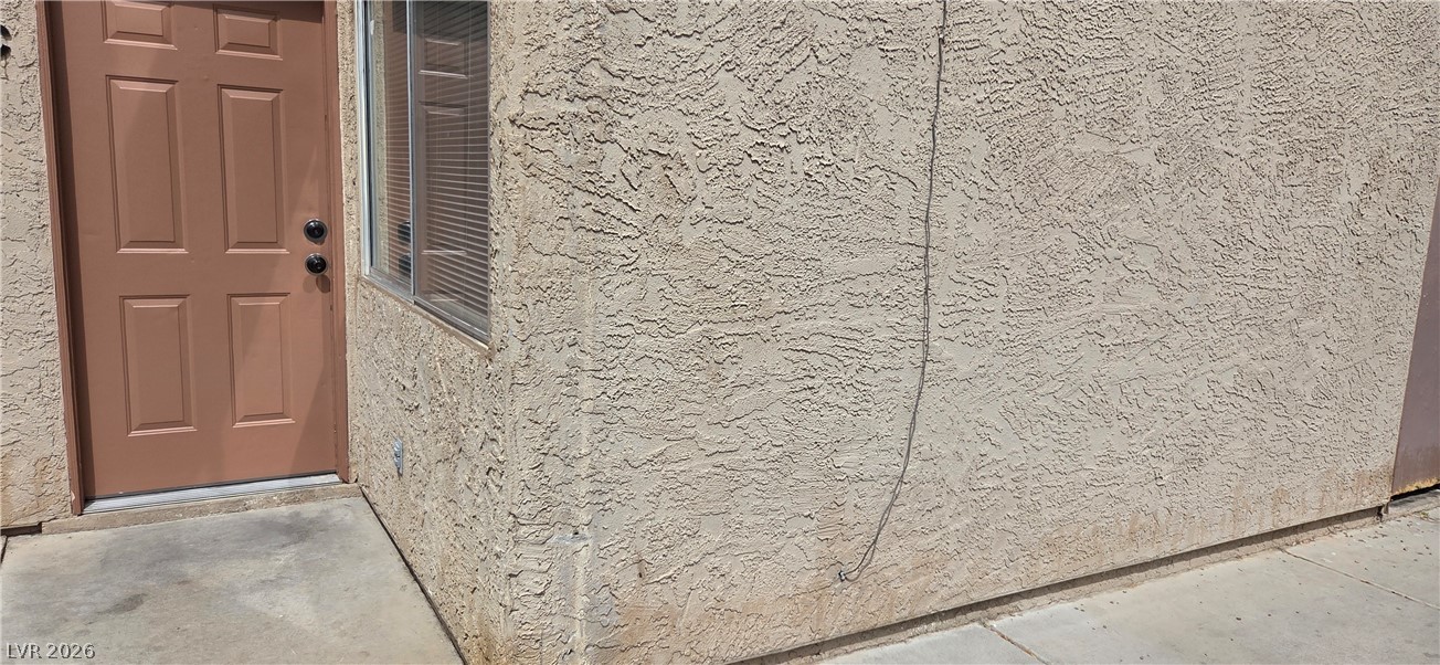571 Roxella Lane, Unit C Las Vegas, NV 89110 - Photo 1 of 14 This residential exterior showcases a stucco finish and practical door and window access.