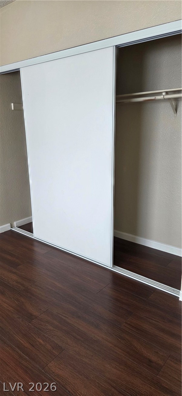 571 Roxella Lane, Unit C Las Vegas, NV 89110 - Photo 3 of 14 This closet features sliding doors and rich wood flooring, offering practical storage.