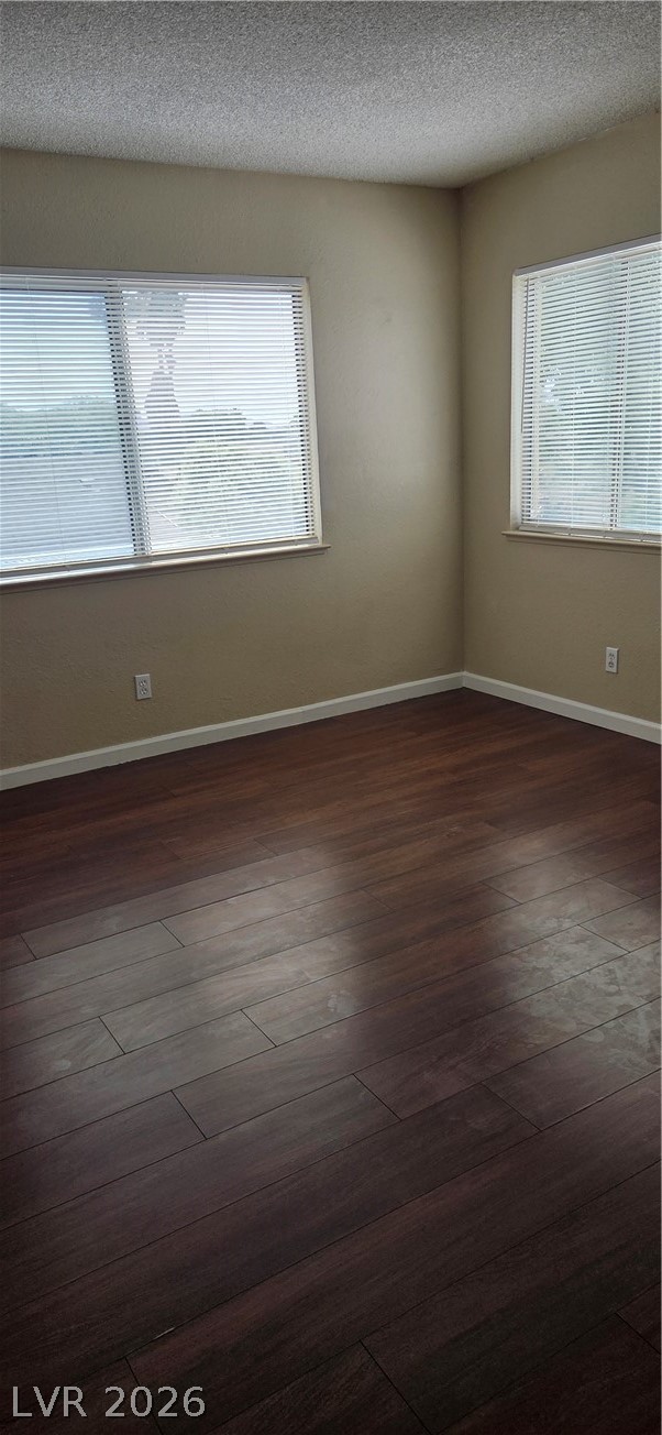 571 Roxella Lane, Unit C Las Vegas, NV 89110 - Photo 9 of 14 This inviting bedroom features rich hardwood flooring and ample natural light through multiple windows.