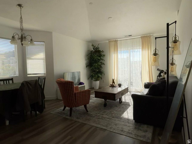 90 East Resaca Drive, Unit C11 Sandy, UT 84070 - Photo 3 of 27 Living area with wood finished floors, vaulted ceiling, and suspended lighting