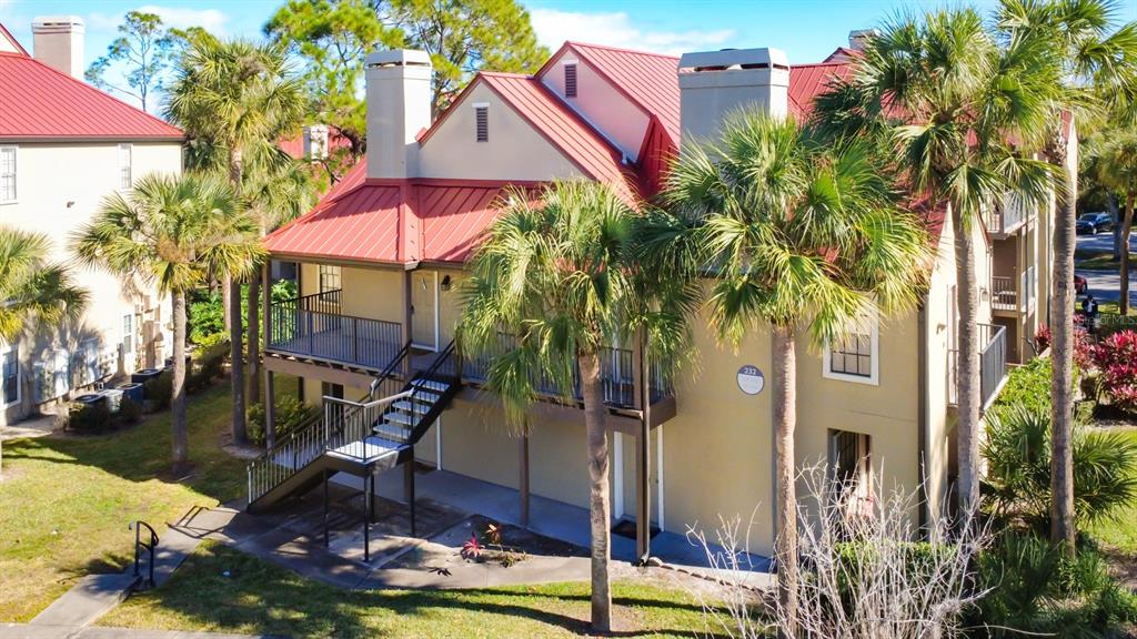 a view of a house with backyard water fountain and sitting area