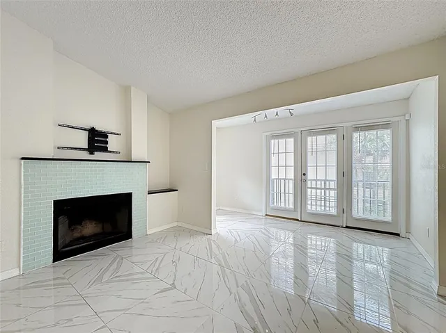 a view of a kitchen with an empty space and a fireplace