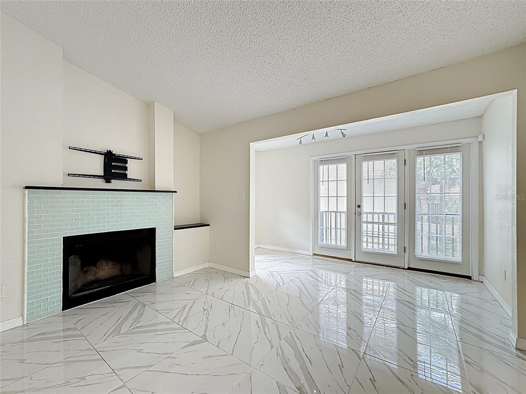 232 Afton Square, Unit 201 Altamonte Springs, FL 32714 - Photo 15 of 54 a view of an empty room with a fireplace and a window
