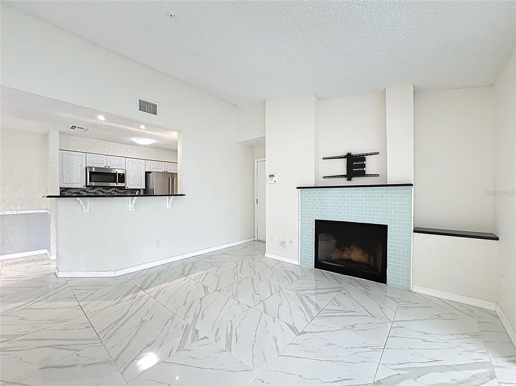 232 Afton Square, Unit 201 Altamonte Springs, FL 32714 - Photo 17 of 54 a view of a kitchen with an empty space and a fireplace