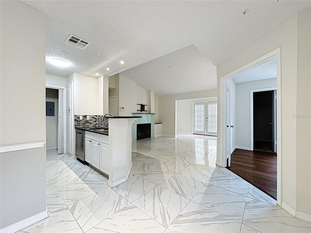 232 Afton Square, Unit 201 Altamonte Springs, FL 32714 - Photo 19 of 54 a kitchen with stainless steel appliances kitchen island granite countertop a refrigerator and a stove top oven