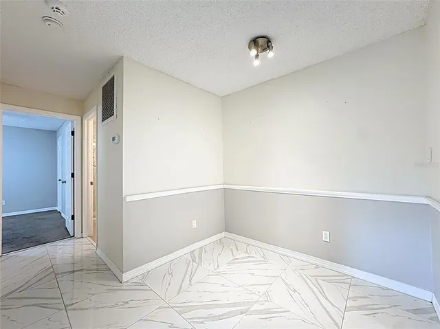 a kitchen with kitchen island a stove and a microwave