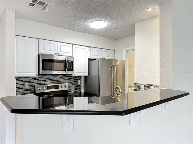 a kitchen with a stove and a microwave