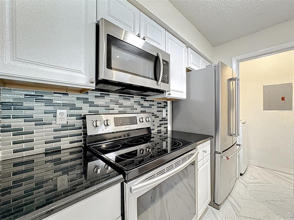 232 Afton Square, Unit 201 Altamonte Springs, FL 32714 - Photo 25 of 54 a kitchen with a stove and a microwave