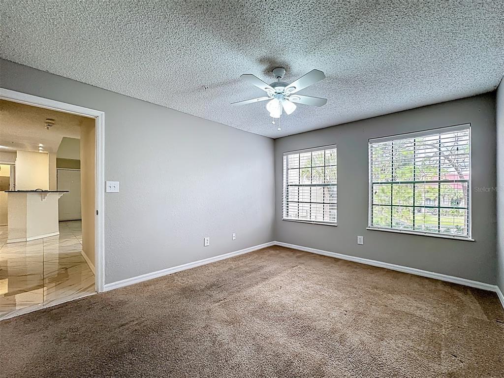 232 Afton Square, Unit 201 Altamonte Springs, FL 32714 - Photo 31 of 54 an empty room with chandelier fan and windows