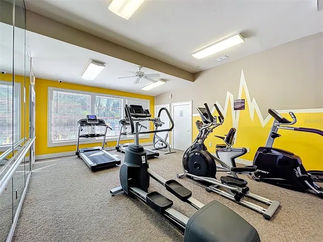 a patio with a table and chairs under an umbrella