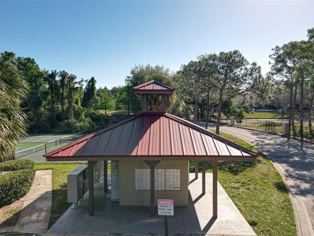 an aerial view of residential houses with outdoor space and lake view