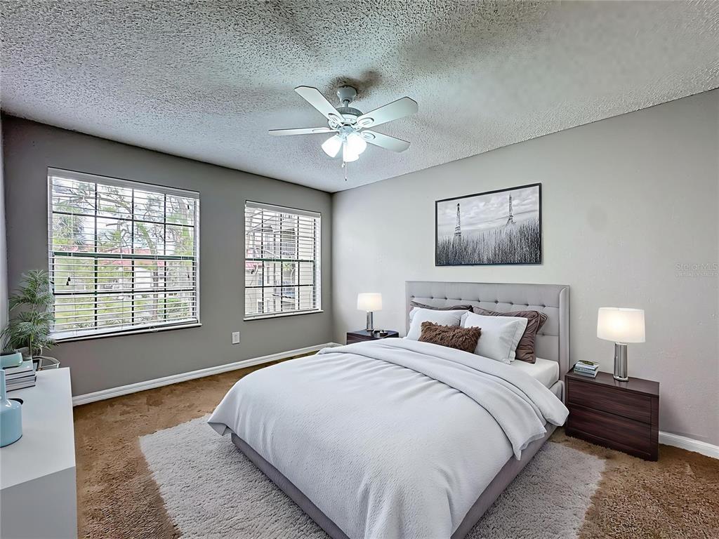 232 Afton Square, Unit 201 Altamonte Springs, FL 32714 - Photo 6 of 54 a bedroom with a bed and a chandelier