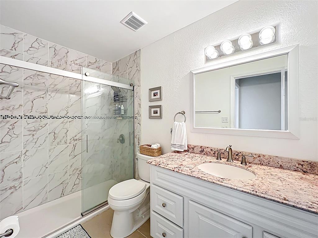 232 Afton Square, Unit 201 Altamonte Springs, FL 32714 - Photo 8 of 54 a bathroom with a granite countertop sink toilet and shower