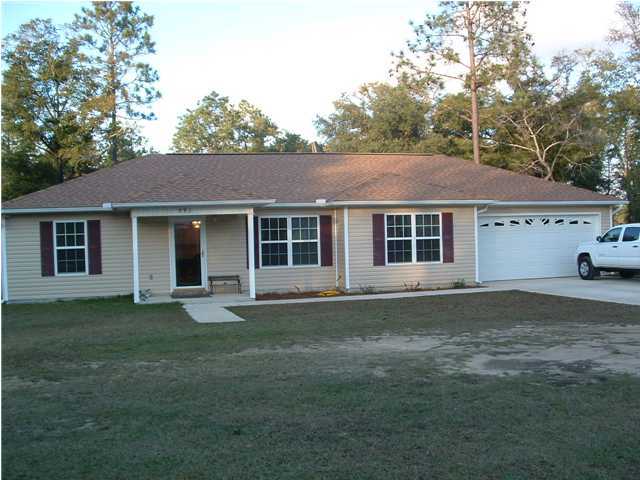 893 Lighthouse Church Road Holt, FL 32564 - Photo 1 of 24 a front view of a house with a garden