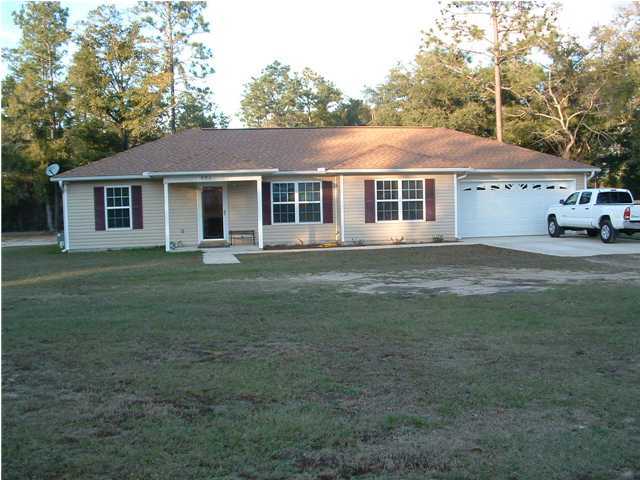 893 Lighthouse Church Road Holt, FL 32564 - Photo 2 of 24 a front view of a house with a garden