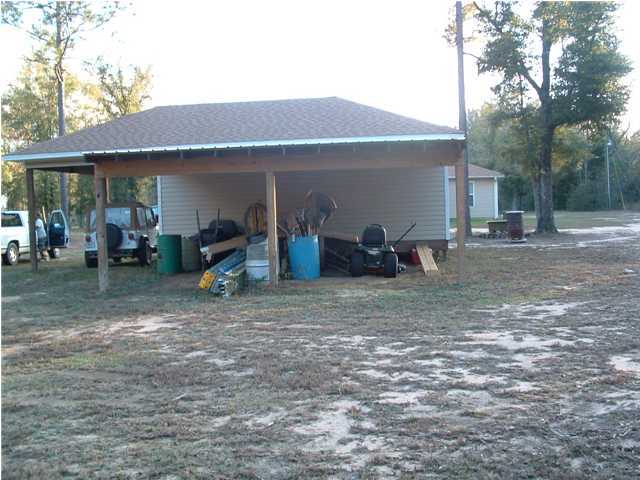 893 Lighthouse Church Road Holt, FL 32564 - Photo 11 of 24 a view of a house with a backyard