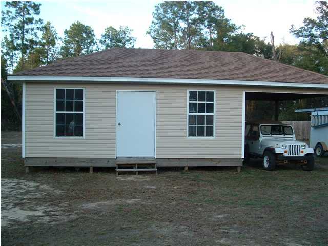 893 Lighthouse Church Road Holt, FL 32564 - Photo 14 of 24 a view of a house with a yard